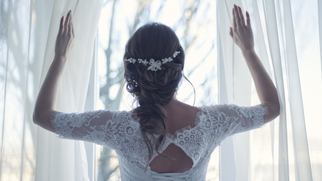 Bride undrawing a curtain